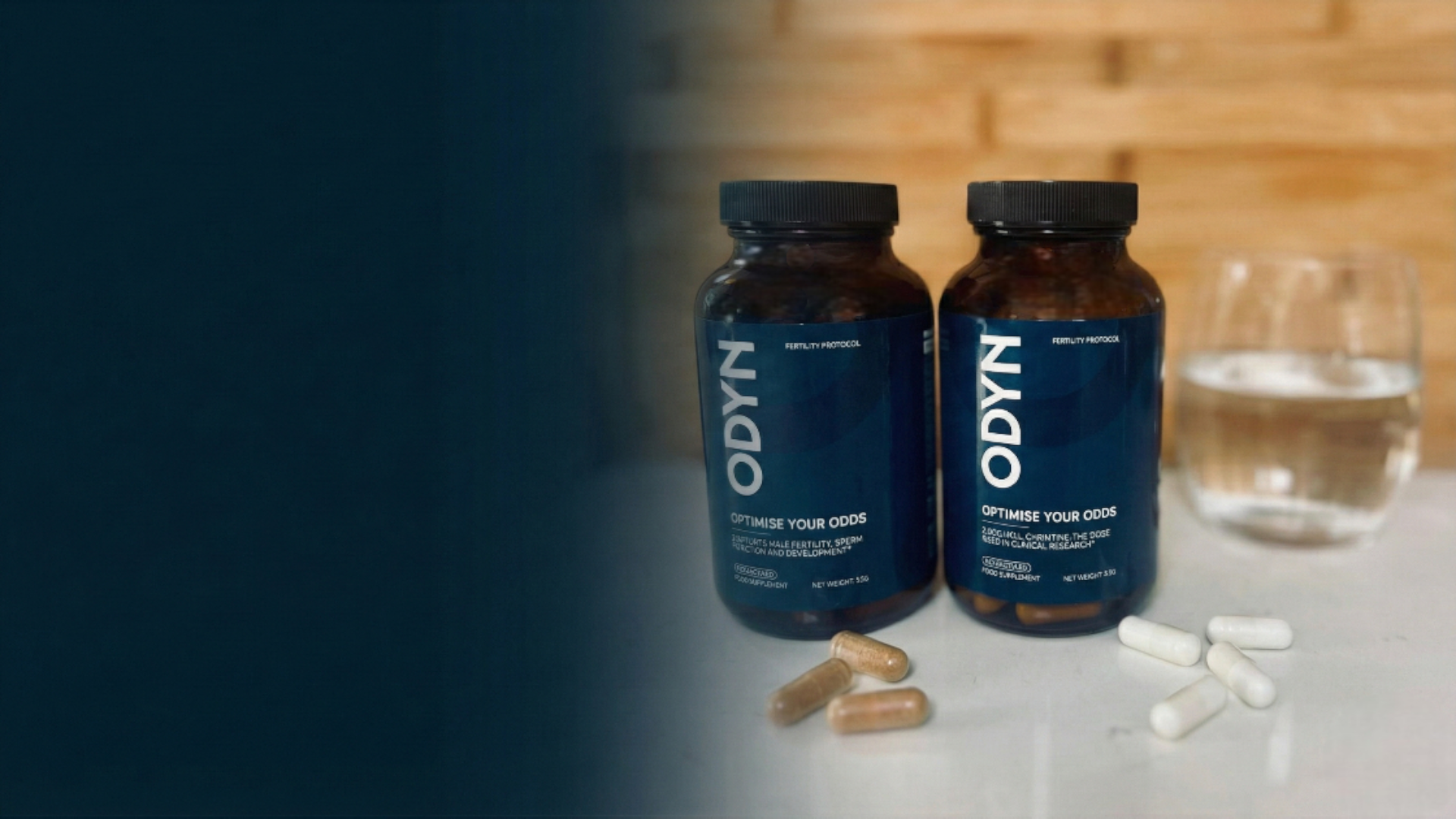 Two ODYN supplement bottles on a table with scattered capsules.